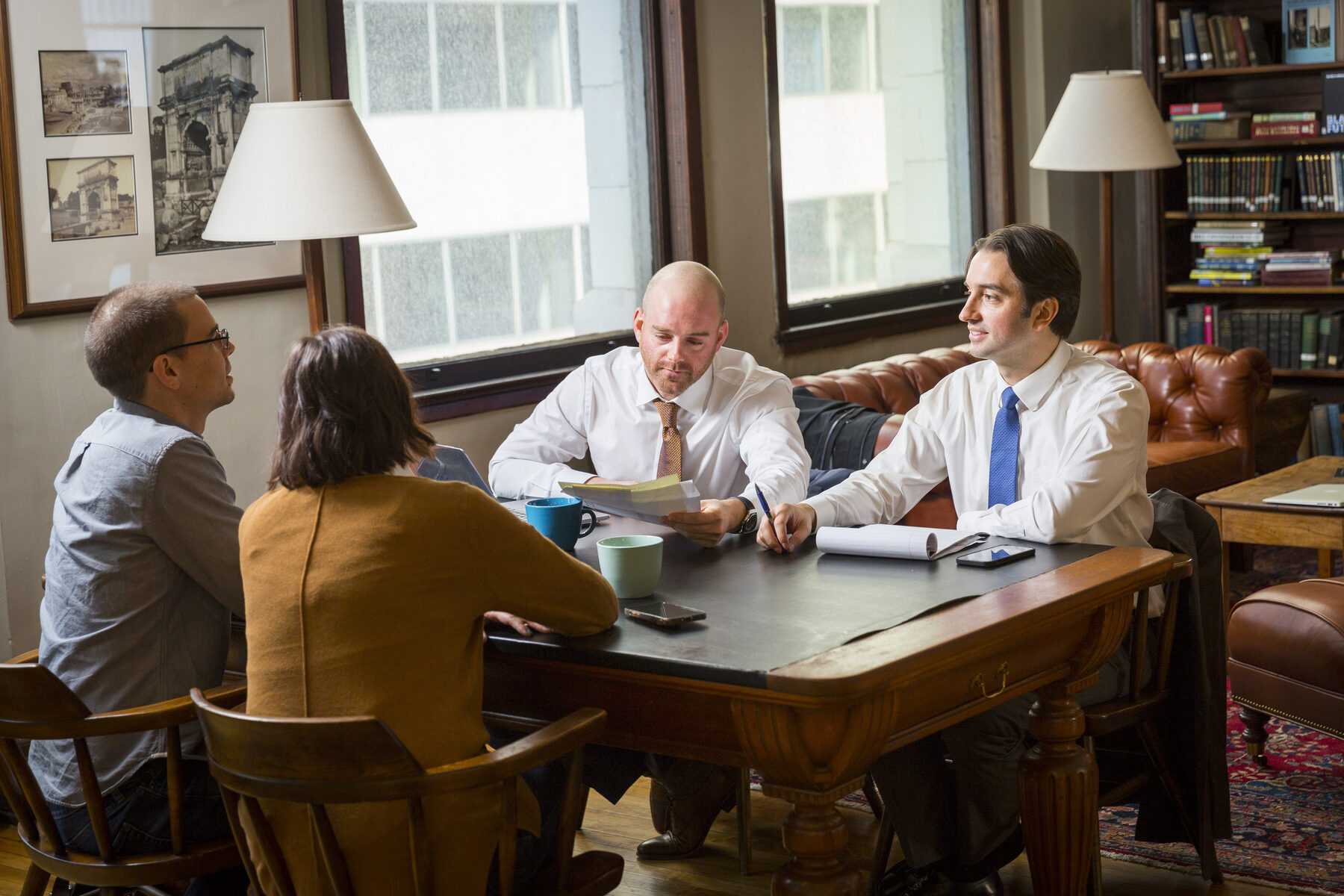 Spivak & Sakellariou attorneys meeting with a client